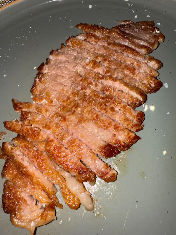 Sliced seared Iberico secreto on a plate