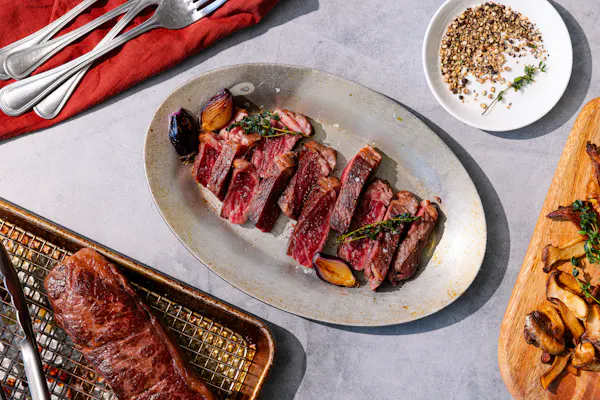 Sliced Denver steak plated with sides
