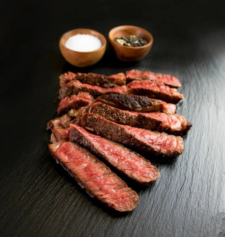 Cooked steak with salt and pepper for garnish