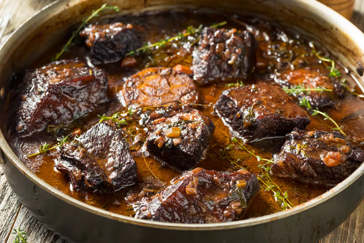 Braised beef in a rich pan sauce with thyme