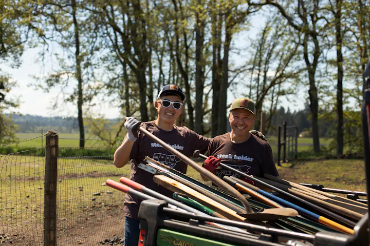 Two Crowd Cow team members working hard on the ranch